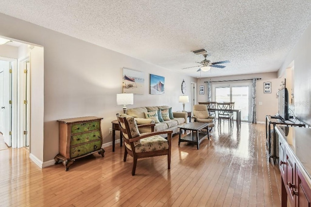 12413 Dawn Vista Dr, Riverview, FL 33578 - living room featuring ceiling fan, light wood-style floors, and a textured ceiling