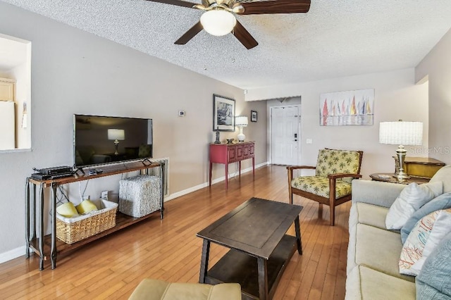 12413 Dawn Vista Dr, Riverview, FL 33578 - living room with a textured ceiling, ceiling fan, and hardwood / wood-style flooring