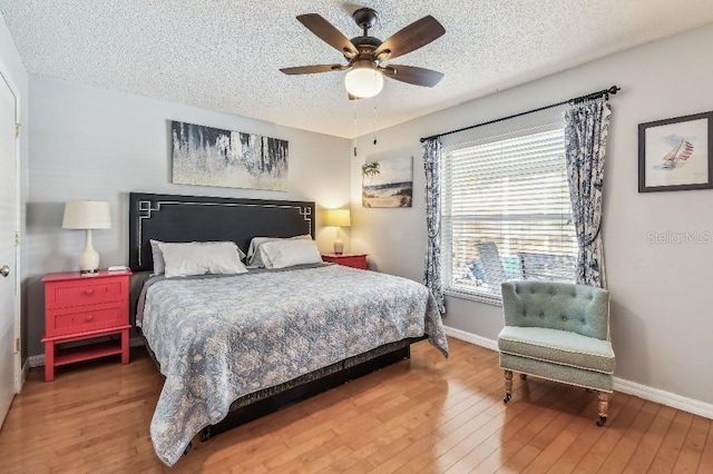 12413 Dawn Vista Dr, Riverview, FL 33578 - bedroom featuring wood-type flooring, a textured ceiling, and a ceiling fan