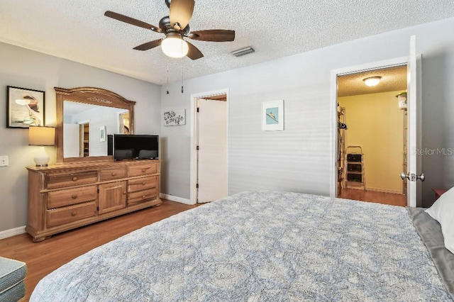 12413 Dawn Vista Dr, Riverview, FL 33578 - bedroom with wood finished floors, a textured ceiling, and a ceiling fan