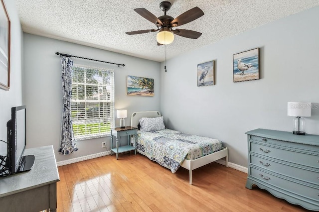 12413 Dawn Vista Dr, Riverview, FL 33578 - bedroom with light wood-style flooring, a textured ceiling, and ceiling fan