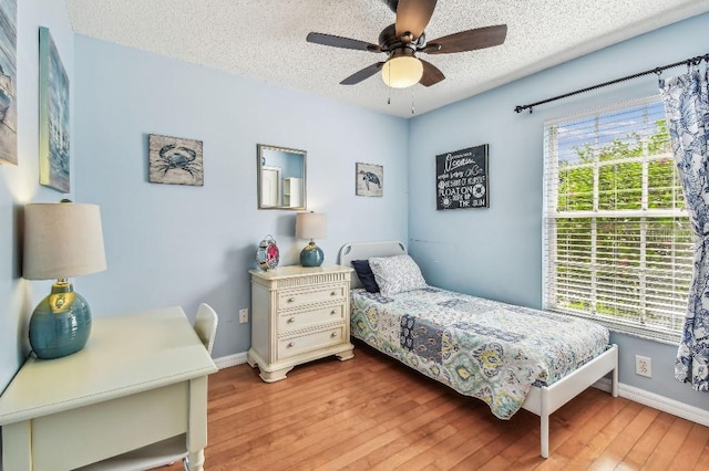 12413 Dawn Vista Dr, Riverview, FL 33578 - bedroom with light wood finished floors, a textured ceiling, and ceiling fan