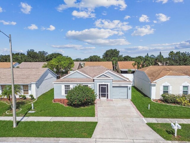 12413 Dawn Vista Dr, Riverview, FL 33578 - ranch-style home featuring an attached garage, driveway, a front yard, and stucco siding