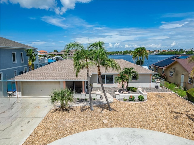 6334 Cocoa Ln, Apollo Beach, FL 33572 - ranch-style house with driveway, an attached garage, a water view, a residential view, and roof with shingles