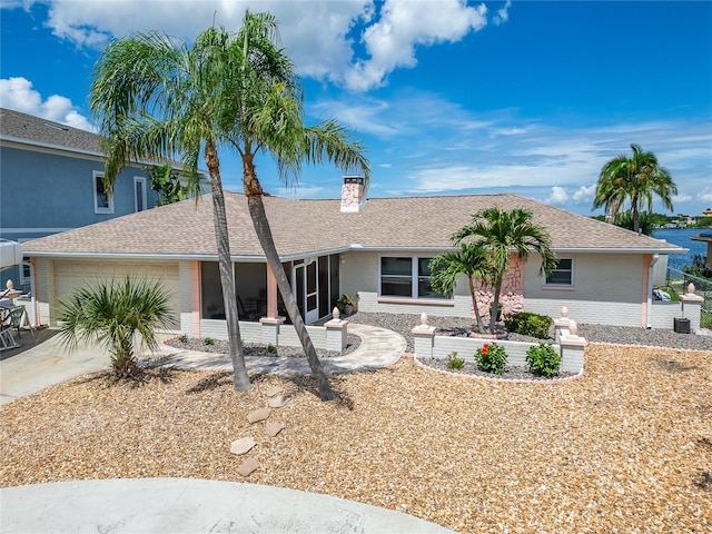 6334 Cocoa Ln, Apollo Beach, FL 33572 - single story home with brick siding, a garage, a chimney, a shingled roof, and concrete driveway