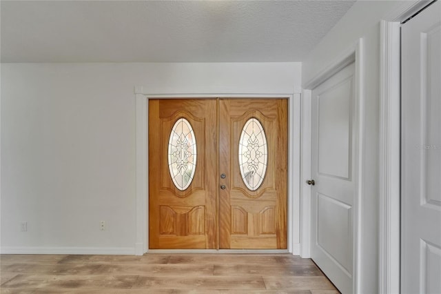 6334 Cocoa Ln, Apollo Beach, FL 33572 - entrance foyer with light wood finished floors and a textured ceiling