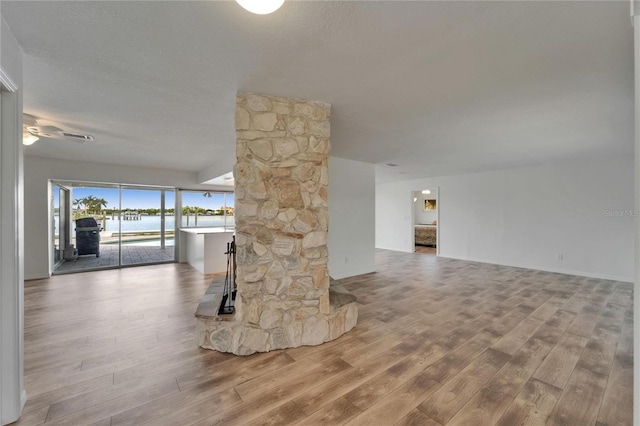 6334 Cocoa Ln, Apollo Beach, FL 33572 - unfurnished living room with wood finished floors, a water view, and a ceiling fan