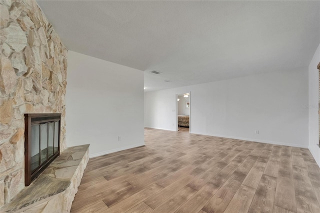 6334 Cocoa Ln, Apollo Beach, FL 33572 - unfurnished living room with light wood finished floors and a fireplace
