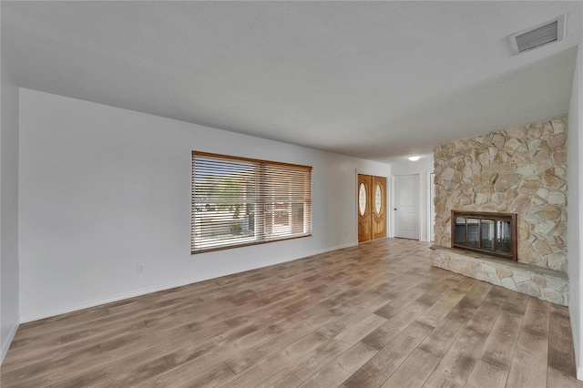 6334 Cocoa Ln, Apollo Beach, FL 33572 - unfurnished living room featuring wood finished floors and a stone fireplace
