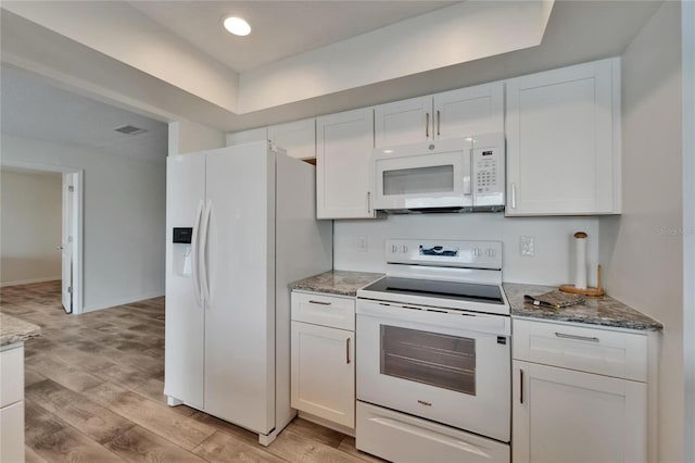 6334 Cocoa Ln, Apollo Beach, FL 33572 - kitchen with white appliances, white cabinetry, light wood-type flooring, light stone counters, and recessed lighting