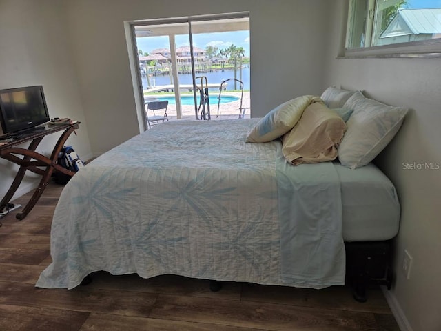 6334 Cocoa Ln, Apollo Beach, FL 33572 - bedroom with access to outside and dark wood-style flooring