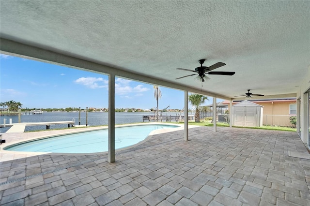 6334 Cocoa Ln, Apollo Beach, FL 33572 - outdoor pool with a ceiling fan, a patio area, a water view, and a storage shed
