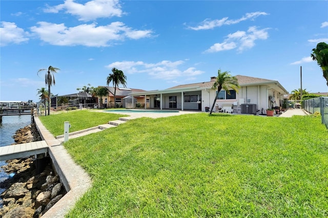6334 Cocoa Ln, Apollo Beach, FL 33572 - rear view of property with a fenced backyard, a water view, a chimney, and a patio area