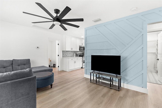 1275 Palm St, Clearwater, FL 33755 - living room with light wood-style floors and ceiling fan