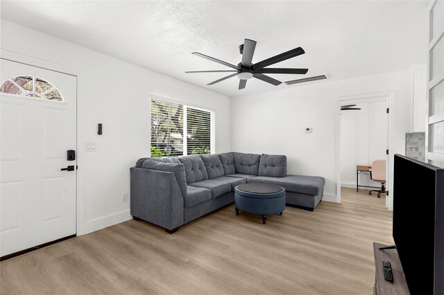 1275 Palm St, Clearwater, FL 33755 - living area with ceiling fan and light wood-style flooring