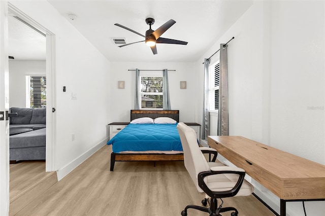 1275 Palm St, Clearwater, FL 33755 - bedroom featuring light wood finished floors, a barn door, and a ceiling fan