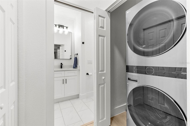 1275 Palm St, Clearwater, FL 33755 - washroom featuring stacked washing machine and dryer and a textured wall