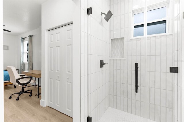 1275 Palm St, Clearwater, FL 33755 - bathroom with a shower stall, wood finished floors, and a closet