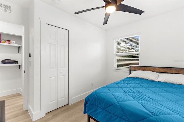 1275 Palm St, Clearwater, FL 33755 - bedroom with light wood finished floors, ceiling fan, and a closet