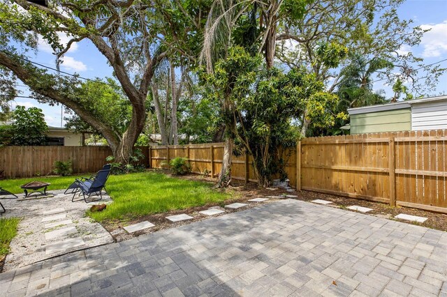 1275 Palm St, Clearwater, FL 33755 - fenced backyard with a patio area and a fire pit
