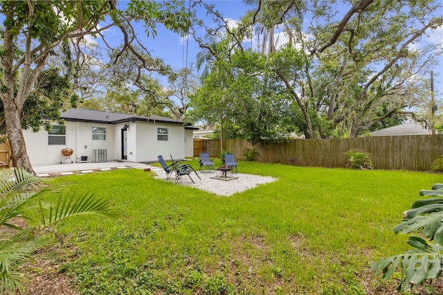 1275 Palm St, Clearwater, FL 33755 - fenced backyard with a patio area and an outdoor fire pit