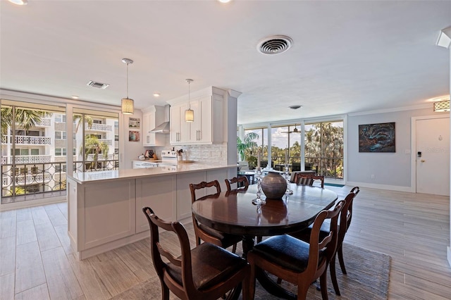 1060 N Shore Dr NE Unit 6, Saint Petersburg, FL 33701 - dining area with light wood-type flooring, recessed lighting, and crown molding