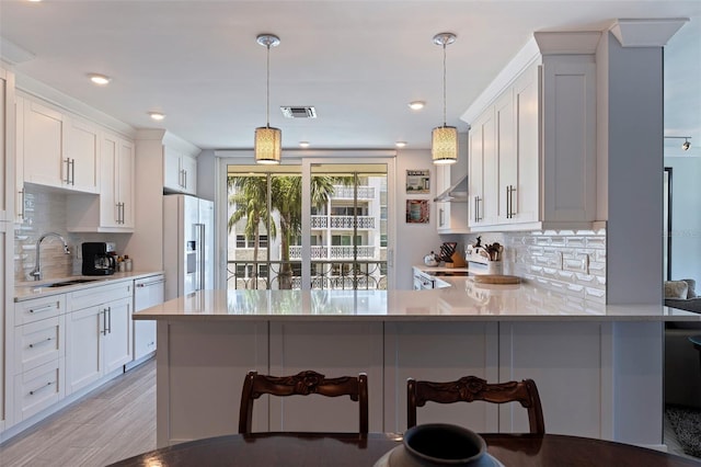 1060 N Shore Dr NE Unit 6, Saint Petersburg, FL 33701 - kitchen featuring high end fridge, range, decorative backsplash, light countertops, and a kitchen breakfast bar