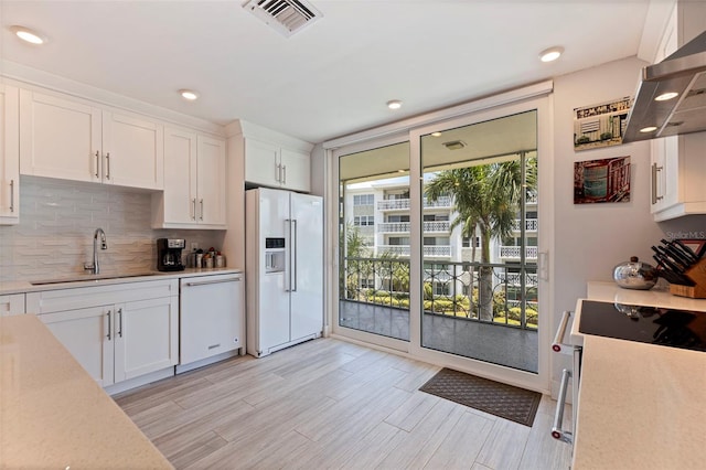 1060 N Shore Dr NE Unit 6, Saint Petersburg, FL 33701 - kitchen with white appliances, extractor fan, white cabinetry, light countertops, and recessed lighting