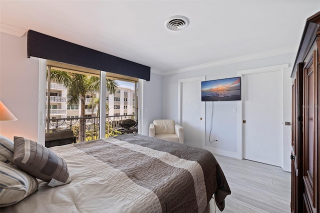 1060 N Shore Dr NE Unit 6, Saint Petersburg, FL 33701 - bedroom with access to outside, light wood-type flooring, and crown molding