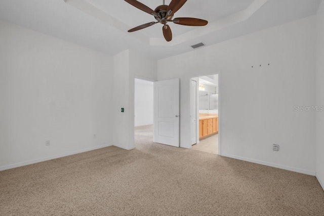 6044 Sandhill Ridge Dr, Lithia, FL 33547 - unfurnished room with light carpet, ceiling fan, and a tray ceiling