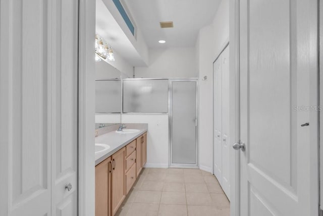6044 Sandhill Ridge Dr, Lithia, FL 33547 - bathroom featuring double vanity, a stall shower, tile patterned floors, a closet, and recessed lighting