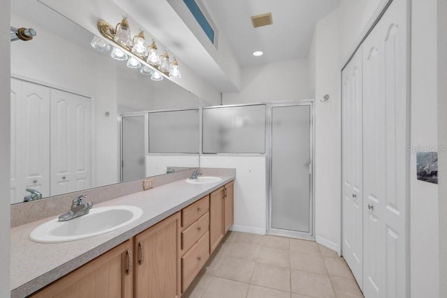 6044 Sandhill Ridge Dr, Lithia, FL 33547 - bathroom featuring a closet, a shower stall, double vanity, and tile patterned flooring