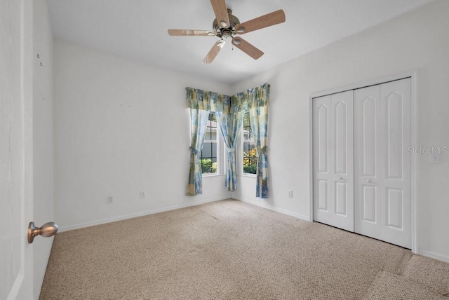 6044 Sandhill Ridge Dr, Lithia, FL 33547 - unfurnished bedroom with carpet flooring, a closet, and a ceiling fan