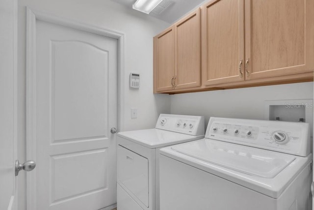 6044 Sandhill Ridge Dr, Lithia, FL 33547 - laundry area with washing machine and clothes dryer and cabinet space