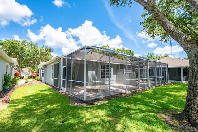 6044 Sandhill Ridge Dr, Lithia, FL 33547 - rear view of property featuring a patio, a lawn, and glass enclosure