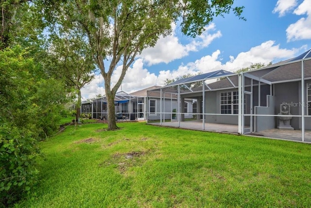 6044 Sandhill Ridge Dr, Lithia, FL 33547 - view of green lawn with glass enclosure and a patio area
