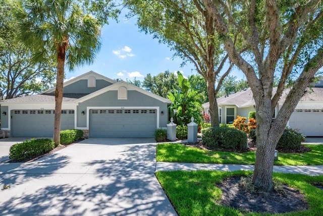 6044 Sandhill Ridge Dr, Lithia, FL 33547 - view of front of property featuring a garage, concrete driveway, stone siding, and stucco siding