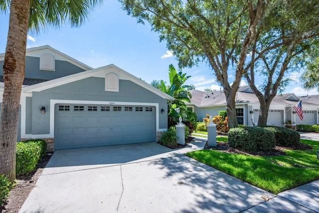 6044 Sandhill Ridge Dr, Lithia, FL 33547 - single story home with stucco siding, a garage, concrete driveway, and stone siding