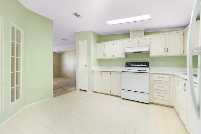 8443 Fantasia Park Way, Riverview, FL 33578 - kitchen featuring white electric range, under cabinet range hood, light flooring, and light countertops