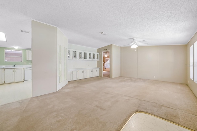 8443 Fantasia Park Way, Riverview, FL 33578 - spare room featuring ceiling fan, a textured ceiling, and light colored carpet