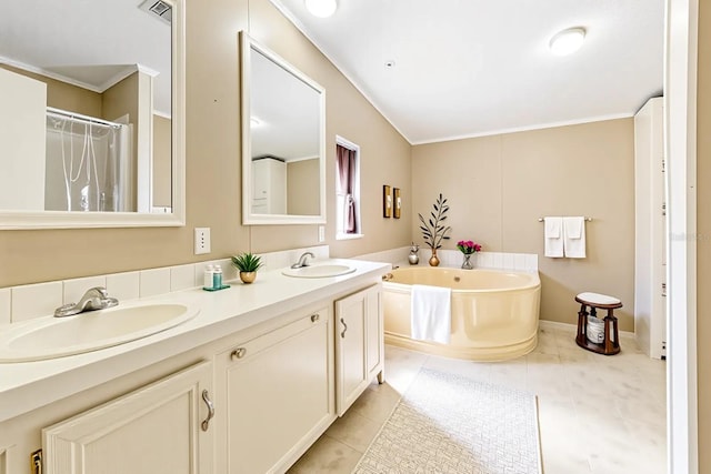 8443 Fantasia Park Way, Riverview, FL 33578 - bathroom featuring crown molding, a bath, double vanity, and tile patterned flooring
