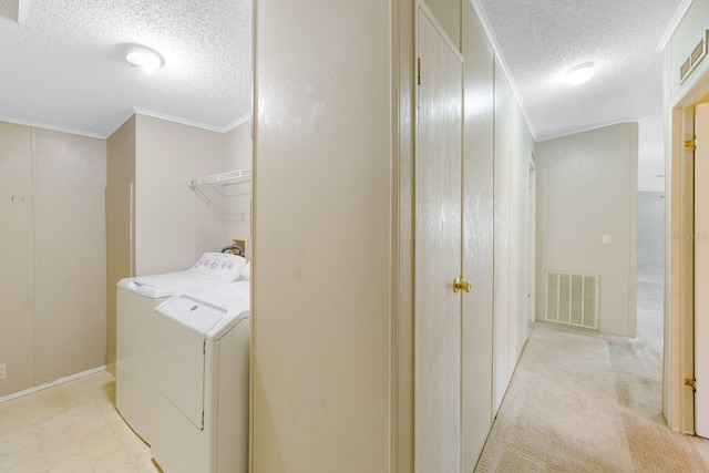 8443 Fantasia Park Way, Riverview, FL 33578 - laundry room featuring a textured ceiling, ornamental molding, and washer and clothes dryer