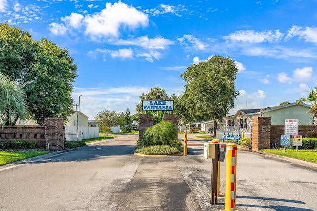 8443 Fantasia Park Way, Riverview, FL 33578 - view of asphalt street featuring curbs, a gated entry, a residential view, and traffic signs