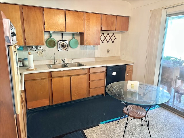 1605 Logan St, Clearwater, FL 33755 - kitchen with black dishwasher, brown cabinetry, and light countertops