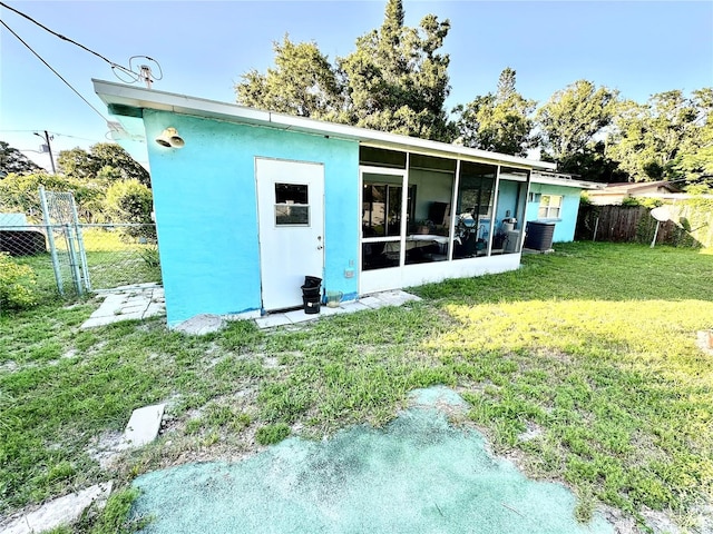 1605 Logan St, Clearwater, FL 33755 - rear view of house featuring a fenced backyard and a sunroom