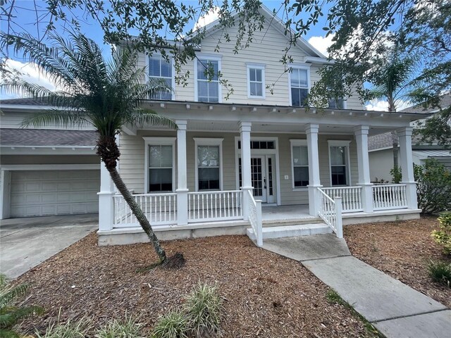405 Islebay Dr, Apollo Beach, FL 33572 - view of front of property with covered porch, concrete driveway, and a garage