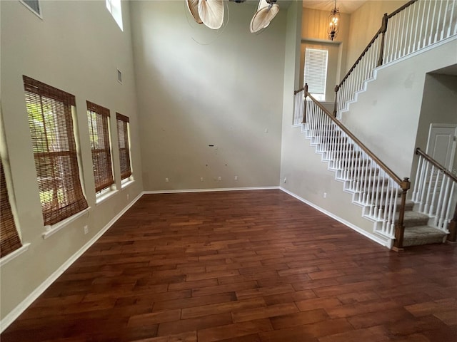 405 Islebay Dr, Apollo Beach, FL 33572 - unfurnished living room featuring wood finished floors, stairway, and a high ceiling