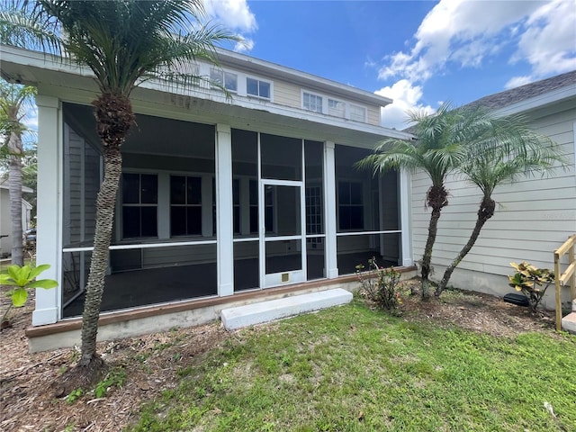 405 Islebay Dr, Apollo Beach, FL 33572 - back of property featuring a sunroom and a lawn