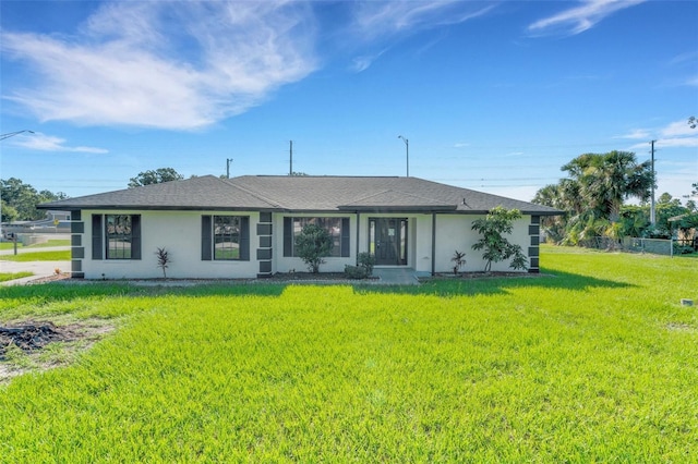 2151 Groveglen Ln S, Lakeland, FL 33813 - view of front of property with stucco siding, a front yard, and a shingled roof