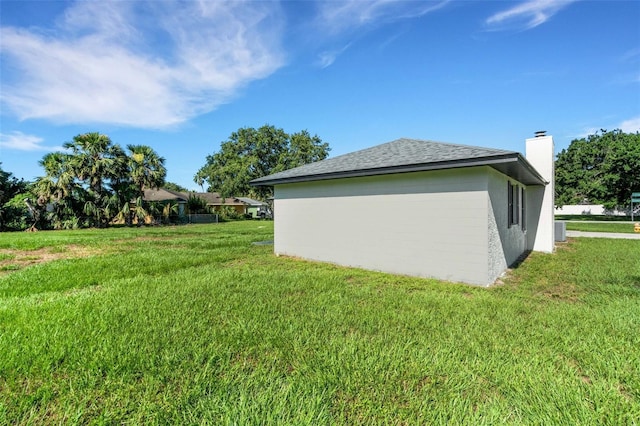 2151 Groveglen Ln S, Lakeland, FL 33813 - view of home's exterior featuring a lawn and a chimney